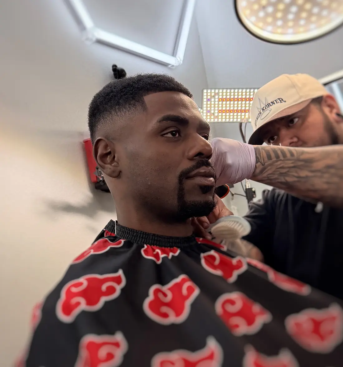 Kings Korner barber finishing a mid fade and beard line-up in San Marcos, Texas